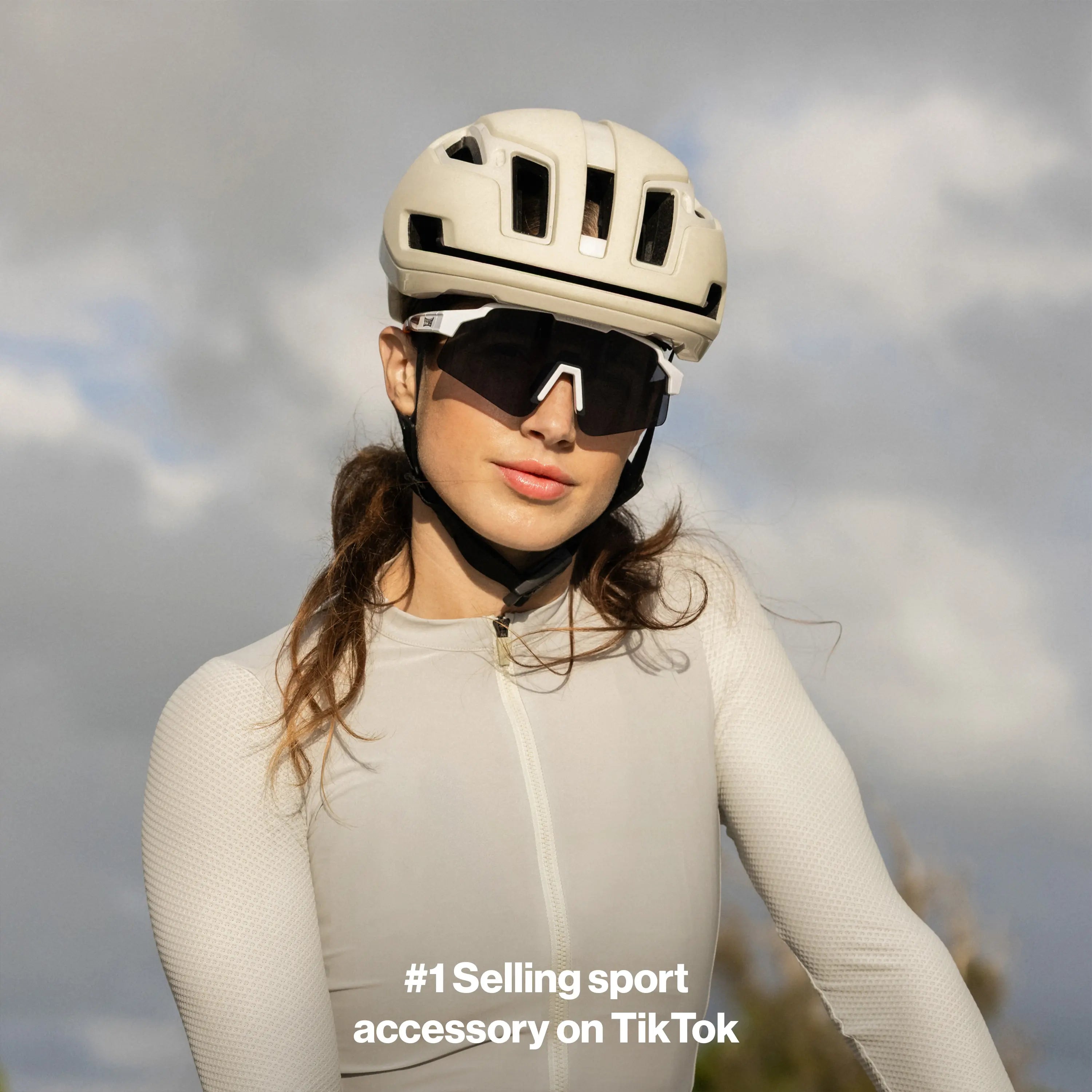 LosReyes SHOWTIME Hurricane Reversed cycling sunglasses with black lens and white frame, worn by cyclist in side profile under helmet