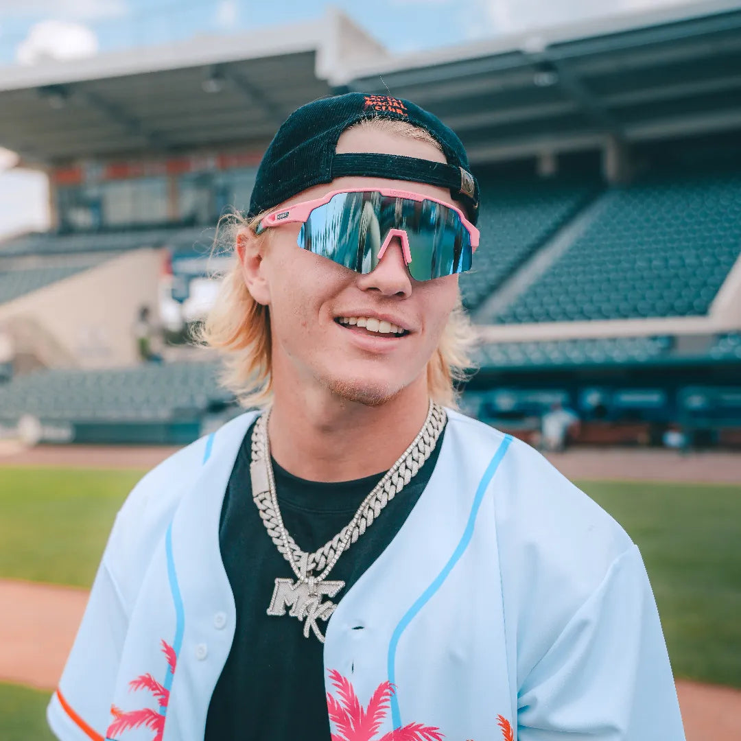 LosReyes Showtime Max Clark Original sunglasses worn on-field by Max Clark, smiling in baseball uniform with mirrored blue lenses reflecting game day energy. 