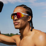 Man wearing LOSREYES Showtime Limited Edition USA 250 sunglasses, red white and blue speckled colorway from the 4th of July drop, by the lake