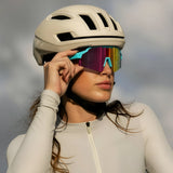 LosReyes SHOWTIME Vice Reversed sunglasses with mirrored multicolor lens and turquoise frame, worn by cyclist adjusting fit under helmet
