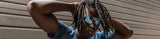 Male athlete with dreadlocks stretching before workout, wearing cool LosReyes wraparound sports premium glasses with uv protection and reflective blue lenses, perfect for basketball training 