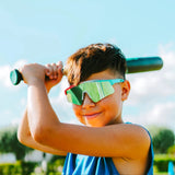 Youth baseball player wearing rocket pop LosReyes sunglasses holding bat