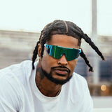 Athlete Ross500 sporting Elevate blue raz LosReyes track sunglasses designed for runners and sprinters, featuring polarized UV400 lenses and aerodynamic TR90 build.